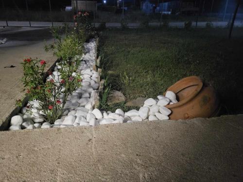 a garden of rocks and flowers in a yard at Countryside apartments ground floor in Gómfoi