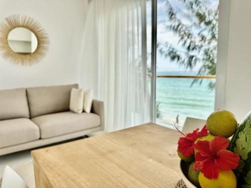 a living room with a table and a view of the ocean at OceanView Penthouse Mirage ZanzibarHouses in Kiwengwa