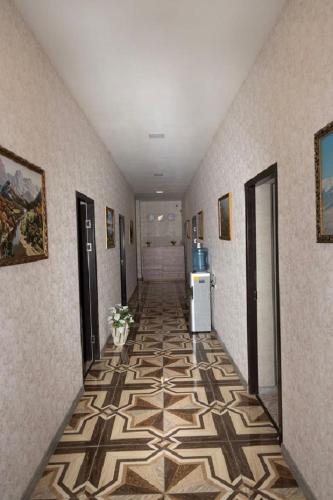 a hallway with a tile floor in a room at NoyemBurg hotel in Noyemberyan