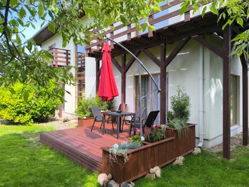 a patio with a table and chairs on a deck at Flip-Flops Apartment Jurmala with free parking in Jūrmala