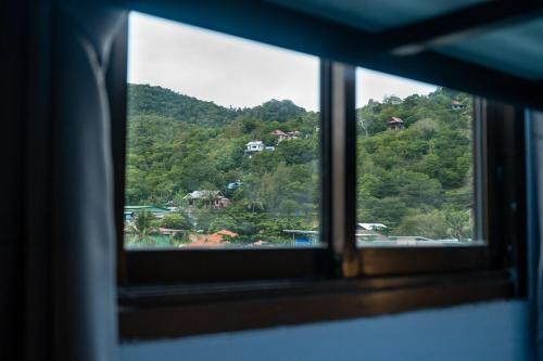 a view of a mountain through a window at Closca Hostel Koh Tao in Koh Tao