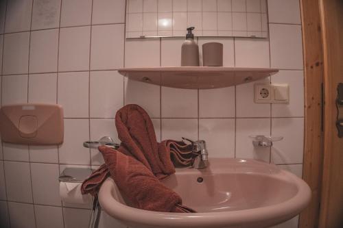 a bathroom with a sink with towels on it at Haus Bergwind in Sankt Leonhard im Pitztal