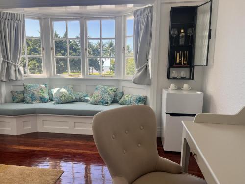 a living room with a window seat with pillows at Floriana Boutique Hotel in Cairns