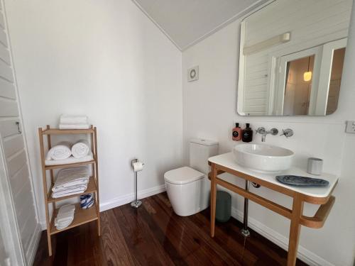 a white bathroom with a sink and a toilet at Floriana Boutique Hotel in Cairns