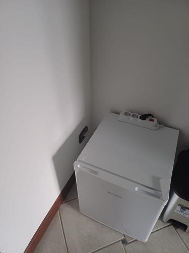 a white refrigerator sitting in a corner of a room at Maryhouse - ingresso indipendente in Venegono Superiore