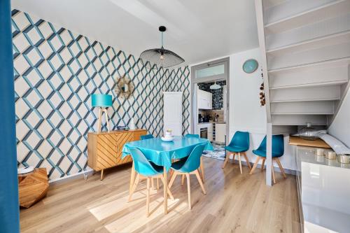 une salle à manger avec une table et des chaises bleues dans l'établissement La Halte Sainte-Catherine - A 15 min de la plage, à Honfleur