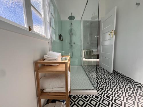 a bathroom with a shower and a walk in shower at Floriana Boutique Hotel in Cairns
