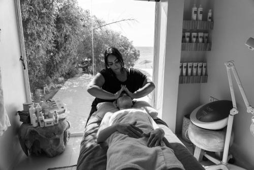 a woman sitting next to a man sitting on a bed at La Crique Nature & Spa in Dakhla