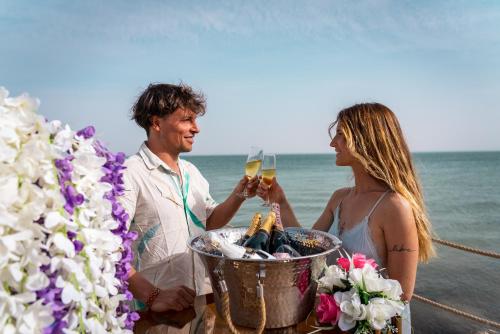 a man and a woman drinking champagne on the beach at La Crique Nature & Spa in Dakhla