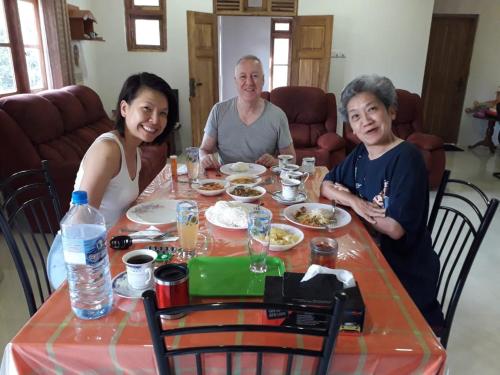 a group of people sitting at a table eating food at Golden Residence in Anuradhapura