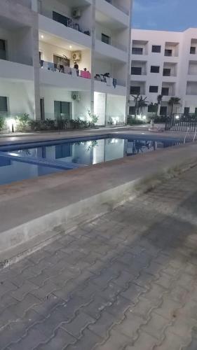 an empty swimming pool in front of a building at Soleil in Mansouria