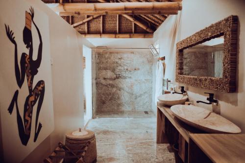 a bathroom with two sinks and a mirror at La Crique Nature & Spa in Dakhla