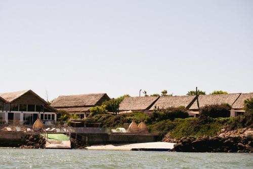 a group of houses on the shore of the water at La Crique Nature & Spa in Dakhla