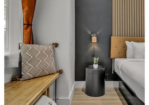 a bedroom with a bed and a bench with a pillow at The Block Hotel in Bentonville