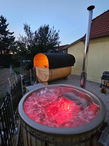 a hot tub with a barrel and a baseball bat at Vířivka a sauna na pokoji,nebo na vlastní terase - Farma u Příbrami in Příbram