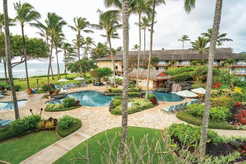 an aerial view of a resort with a pool and palm trees at Kauai Coast Resort at the Beach Boy in Kapaa