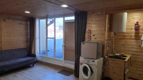 a kitchen with a refrigerator and a washing machine at NAREK B&B in Goris