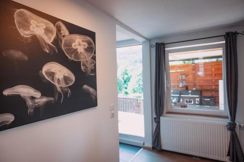 a room with a painting of butterflies on the wall at Bungalow Donaublick mit Pool und Garten in Sankt Nikola an der Donau