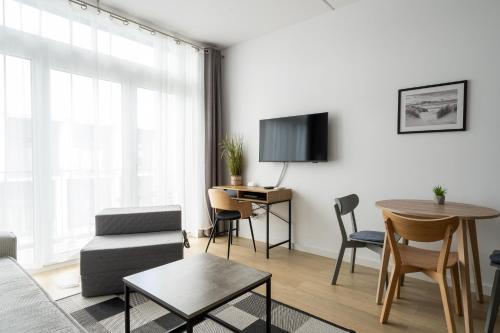 a living room with a couch and a table at RentPlanet - Apartamenty Zarembowicza in Wrocław