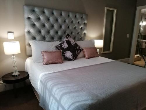 a bedroom with a large bed with pillows on it at Mandela Rhodes Place in Cape Town