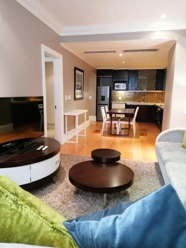 a living room with a couch and a table at Mandela Rhodes Place in Cape Town