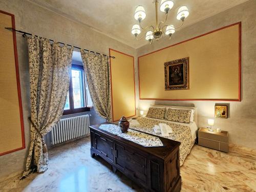 a bedroom with a bed and a table and a window at Domus Clara - guest house Venosa in Venosa