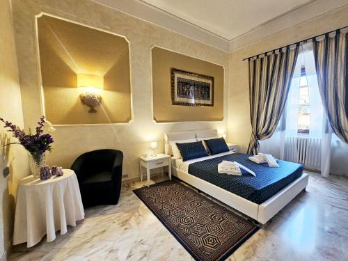 a bedroom with a king sized bed and a table at Domus Clara - guest house Venosa in Venosa