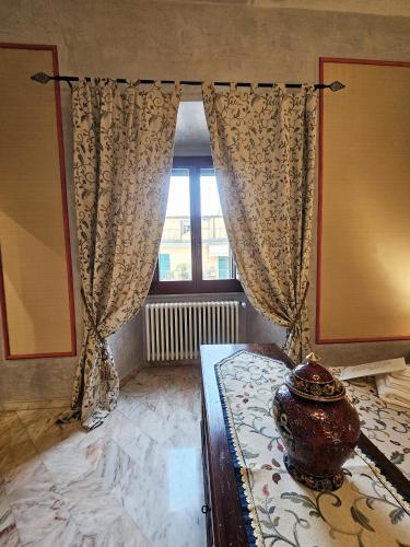 a bedroom with a vase on a bed with a window at Domus Clara - guest house Venosa in Venosa