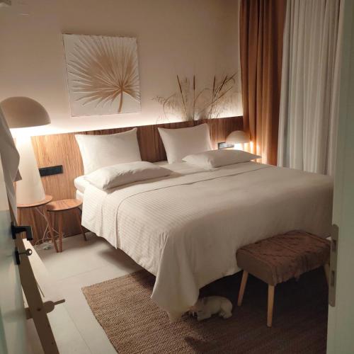 a bedroom with a large bed with a dog laying on the floor at Contessa Suites in Lefkada Town