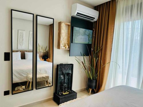 a bedroom with a bed and a large mirror at Contessa Suites in Lefkada Town