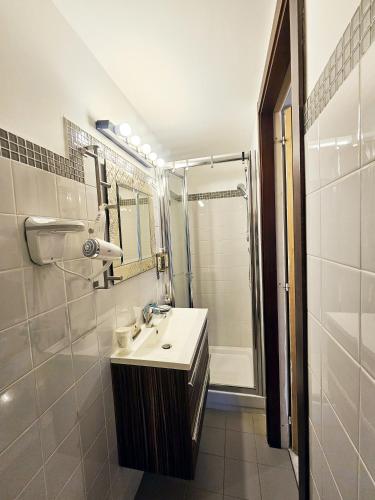 a bathroom with a sink and a shower at Domus Clara - guest house Venosa in Venosa