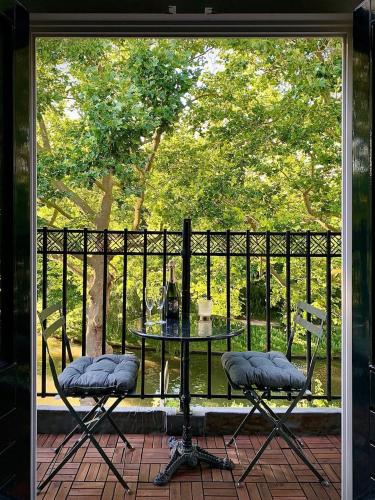 a patio with a table and two chairs on a porch at Suite Canalhouse Majestic in Utrecht