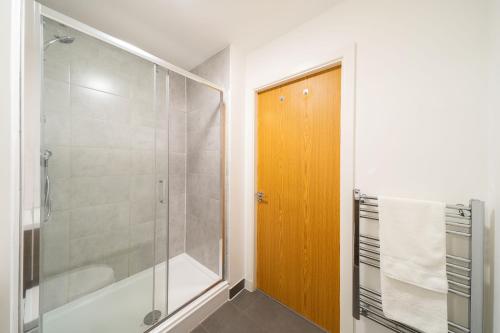 a bathroom with a shower and a glass shower backdoor at Castle Street Apartment in Dundee
