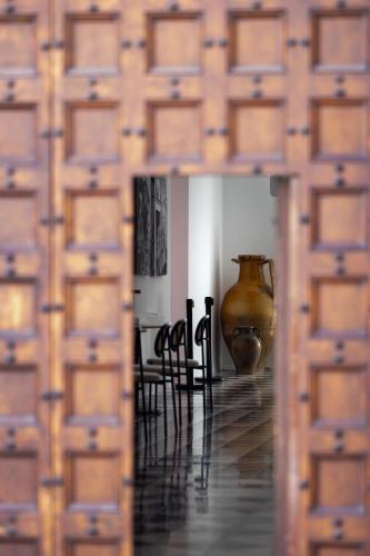 a view of a room with a vase and chairs at Palazzo Piccinno in Parabita
