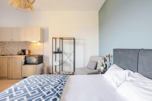 a bedroom with a large bed and a kitchen at Studio Sea View in Agia Pelagia