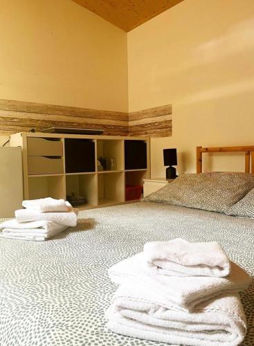 a bedroom with white towels on a bed at CAMPING AMALASUNTA in Montefiascone