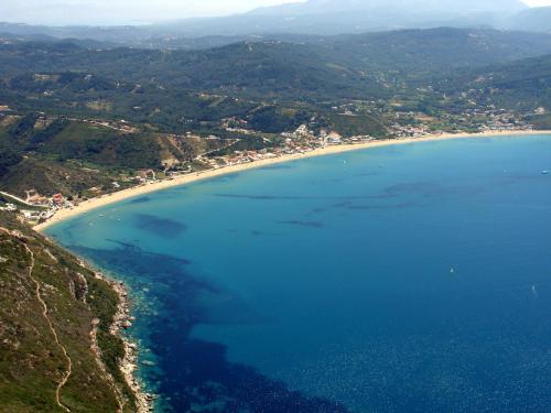 an aerial view of a beach with blue water at Vassilis Paradise Garden Aparthotel in Agios Georgios Pagon