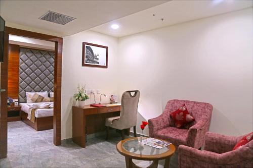 a living room with a desk and two chairs at Hotel Hyderabad Grand in Shamshabad