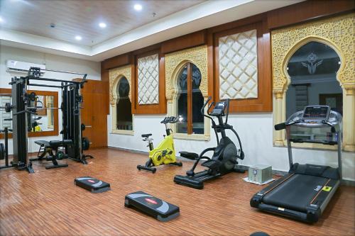 a gym with several exercise equipment in a room at Hotel Hyderabad Grand in Shamshabad