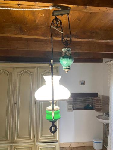a kitchen with two lights hanging from a ceiling at Agriturismo Al Vecio Caselo (Casa Maga) in Arsiero