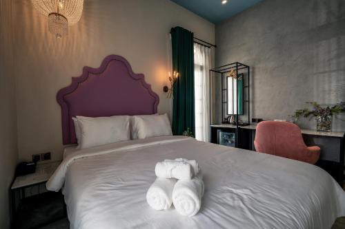 Ένα ή περισσότερα κρεβάτια σε δωμάτιο στο HOTEL le JARDIN SECRET saigon