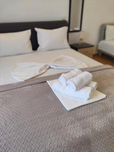 a bed with two towels on top of it at Lula Apartments in Ulcinj