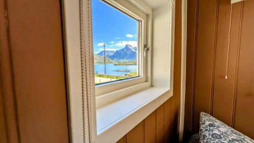 a window in a room with a view of a mountain at Exclusive and Cosy! Sea and Mountian View - Superfast Wifi, Washer and more included in Sortland