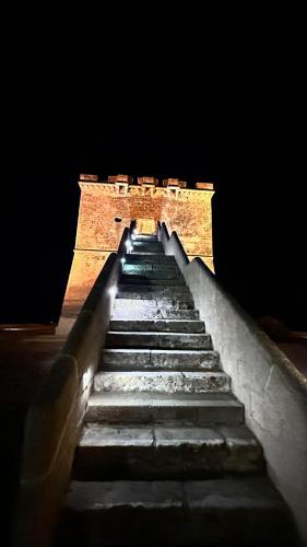 a set of stairs leading up to a brick wall at La Dimora del Salento in Torre Lapillo