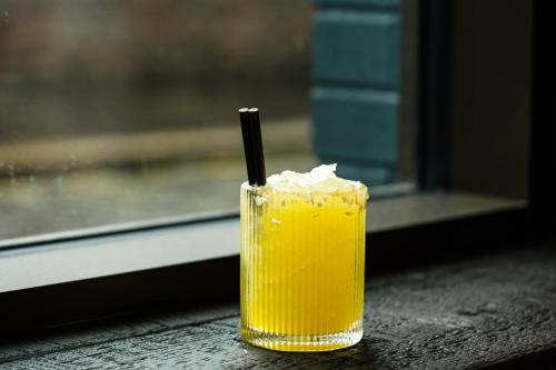 a drink with a black straw sitting on a table at The Foundry in Belfast