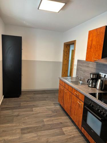 a kitchen with a sink and a stove top oven at Ferienwohnung Hendrich Sotterhausen 2 in Sotterhausen