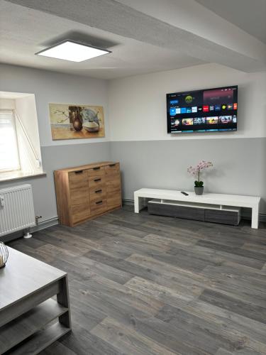 a living room with a tv on the wall at Ferienwohnung Hendrich Sotterhausen 2 in Sotterhausen