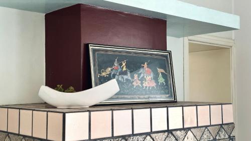 a painting on a wall with a bowl on a table at J01 - Jesi, trilocale nelle mura del centro storico in Iesi