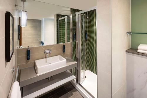 a bathroom with a sink and a shower at DoubleTree by Hilton Leeds in Leeds