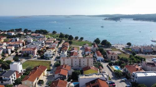 an aerial view of a town next to the water at Osvit Grand Deluxe Apartment in Medulin